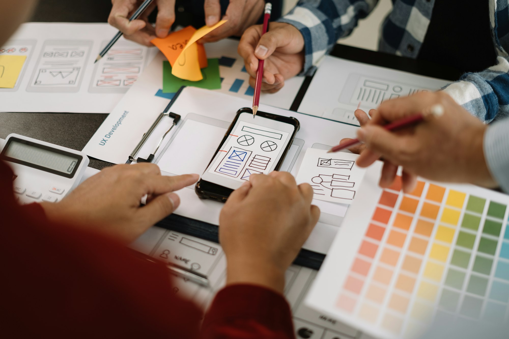 Creative male web designer planning application development for web mobile phone